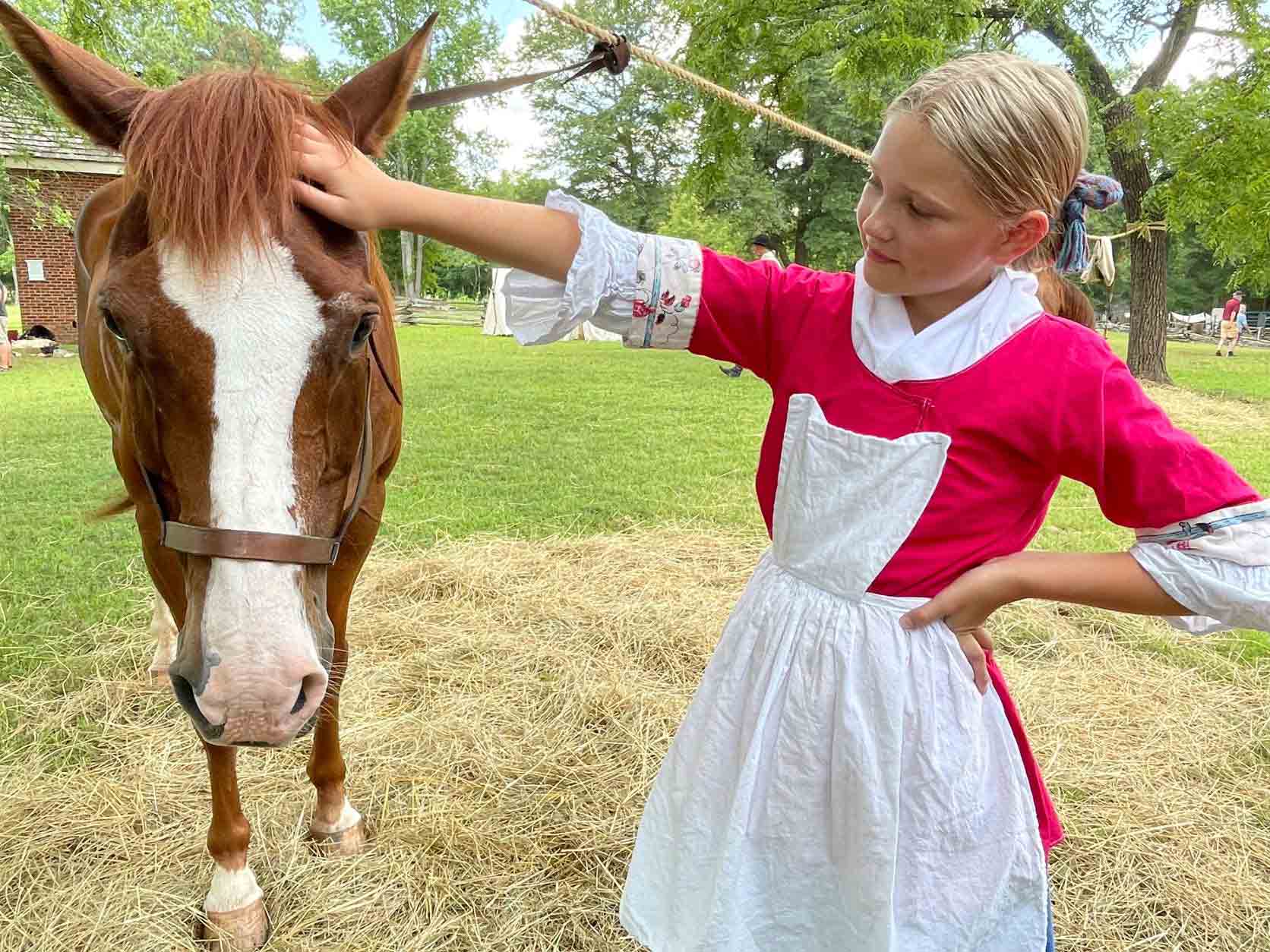 18th century girl petting horse