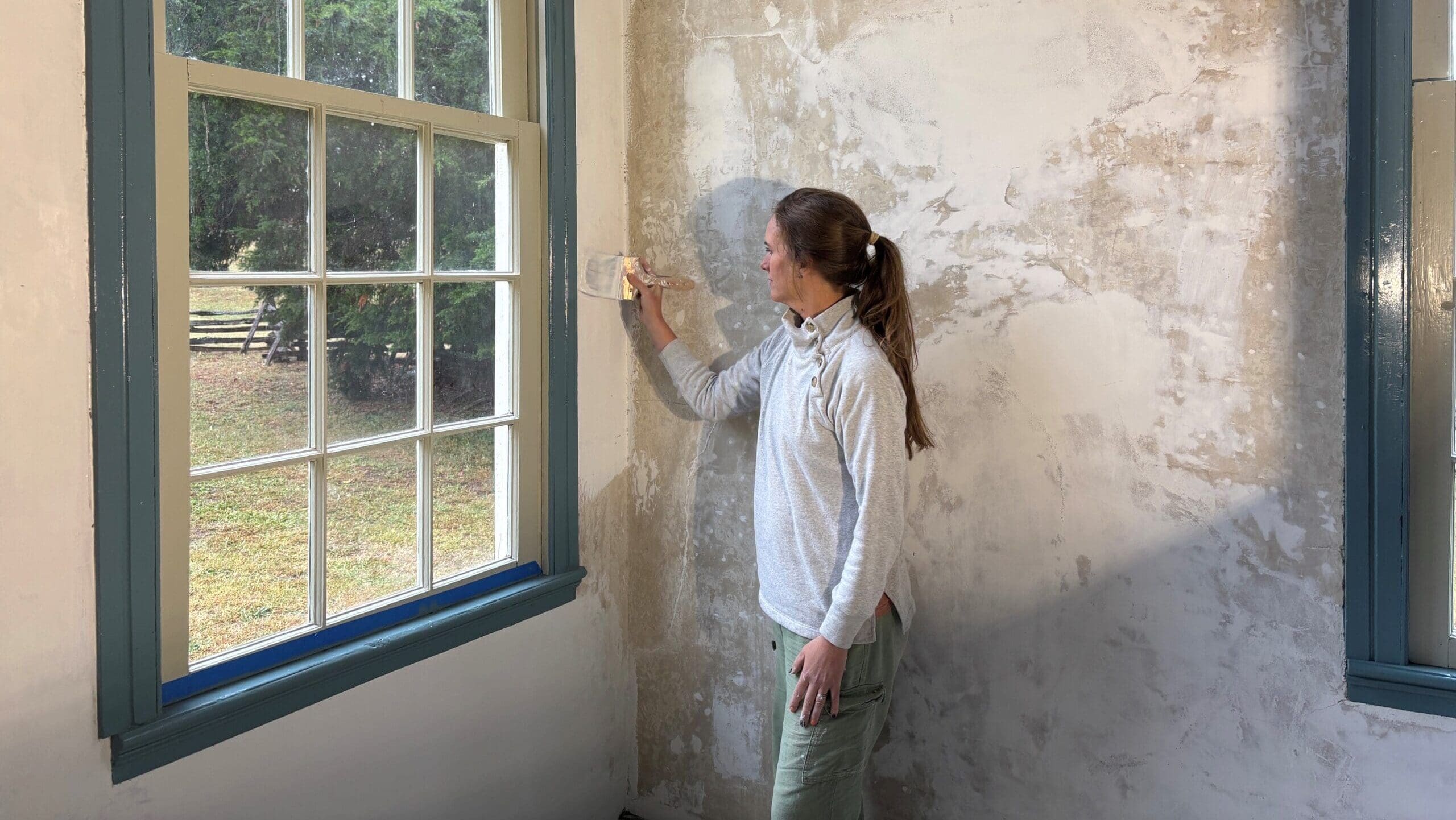 Preservation team painting wall at Historic Brattonsville
