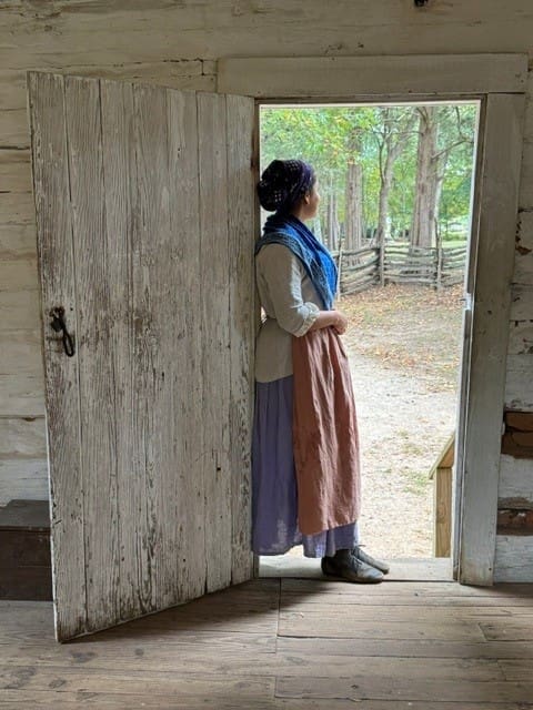 African American History interpreter looking through a door